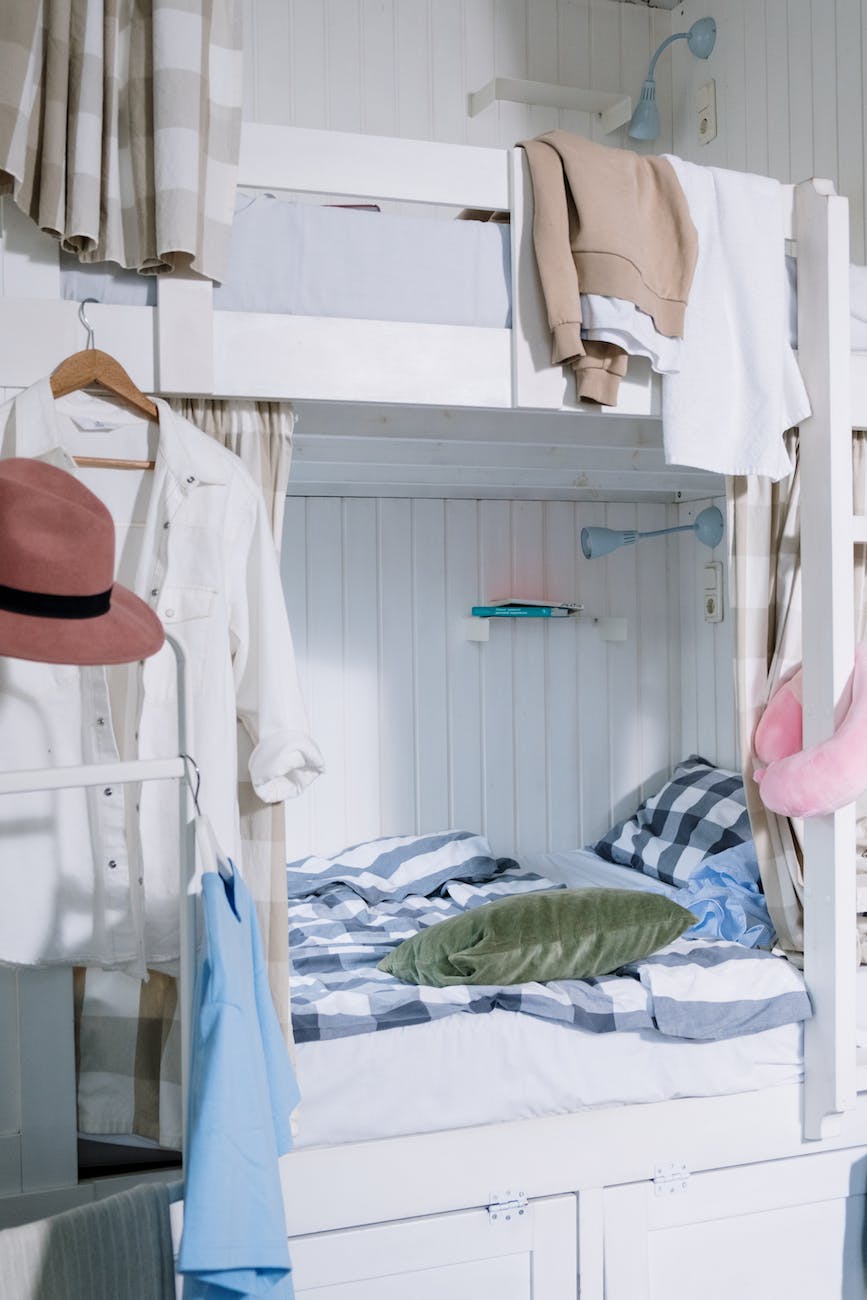 clothes hanging on a bunk bes